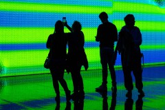 analoge Besucher vor digitalem Kunstwerk